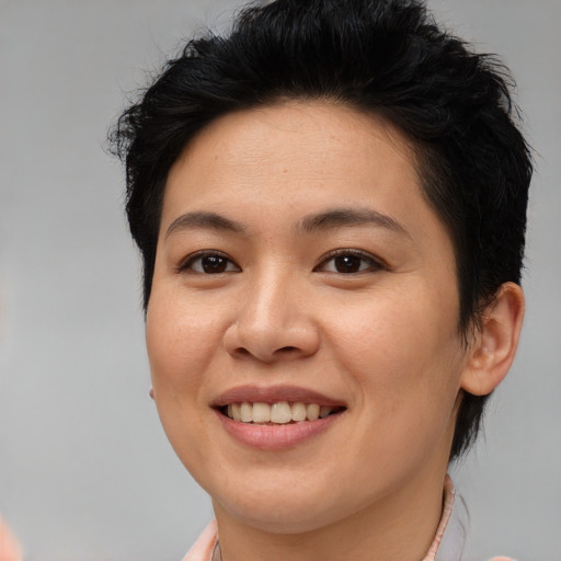 Joyful asian young-adult female with short  brown hair and brown eyes