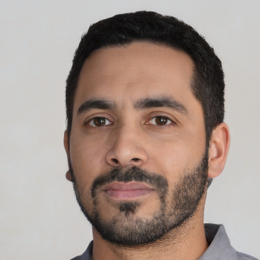 Neutral latino young-adult male with short  black hair and brown eyes