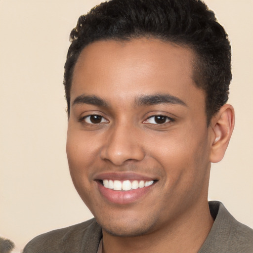 Joyful white young-adult male with short  black hair and brown eyes