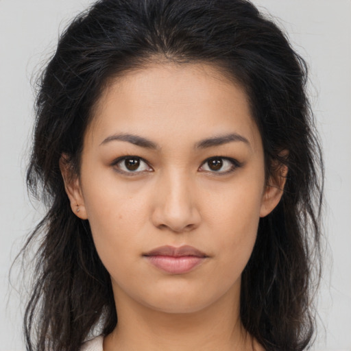 Neutral latino young-adult female with long  brown hair and brown eyes