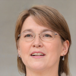 Joyful white adult female with medium  brown hair and blue eyes