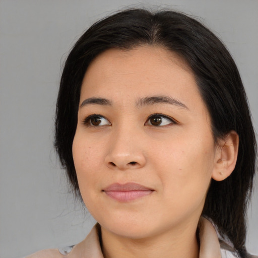 Joyful asian young-adult female with medium  black hair and brown eyes
