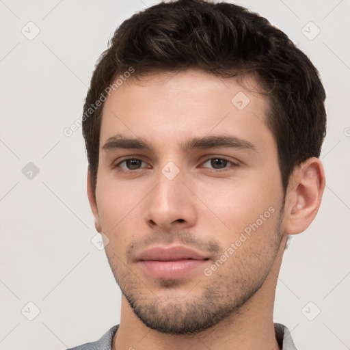 Neutral white young-adult male with short  brown hair and brown eyes