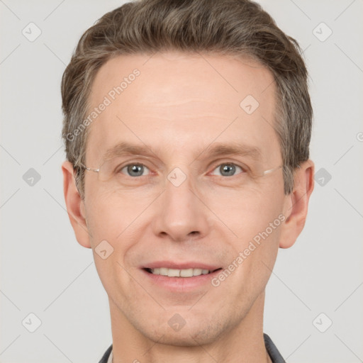 Joyful white adult male with short  brown hair and grey eyes