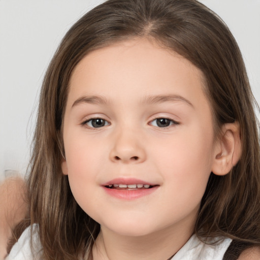 Joyful white child female with medium  brown hair and brown eyes