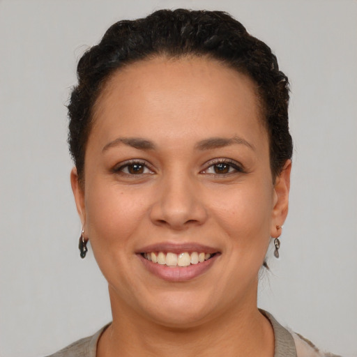 Joyful latino young-adult female with short  brown hair and brown eyes