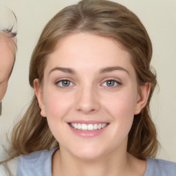 Joyful white young-adult female with medium  brown hair and blue eyes