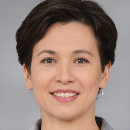 Joyful white adult female with short  brown hair and brown eyes