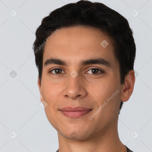 Joyful white young-adult male with short  black hair and brown eyes