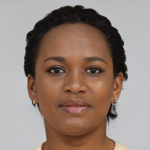 Joyful black young-adult female with short  brown hair and brown eyes