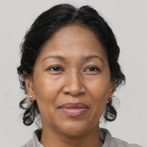 Joyful black adult female with medium  brown hair and brown eyes