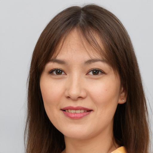 Joyful white young-adult female with long  brown hair and brown eyes