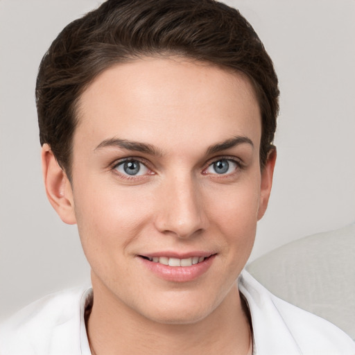 Joyful white young-adult female with short  brown hair and grey eyes