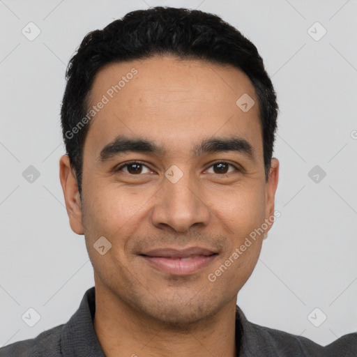 Joyful latino young-adult male with short  black hair and brown eyes