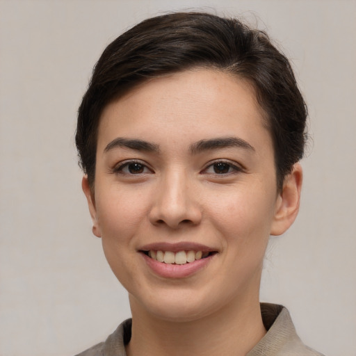 Joyful white young-adult female with short  brown hair and brown eyes