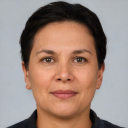 Joyful white adult female with short  brown hair and brown eyes