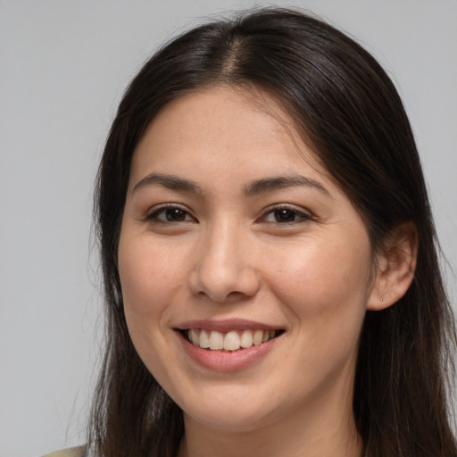 Joyful white young-adult female with long  brown hair and brown eyes