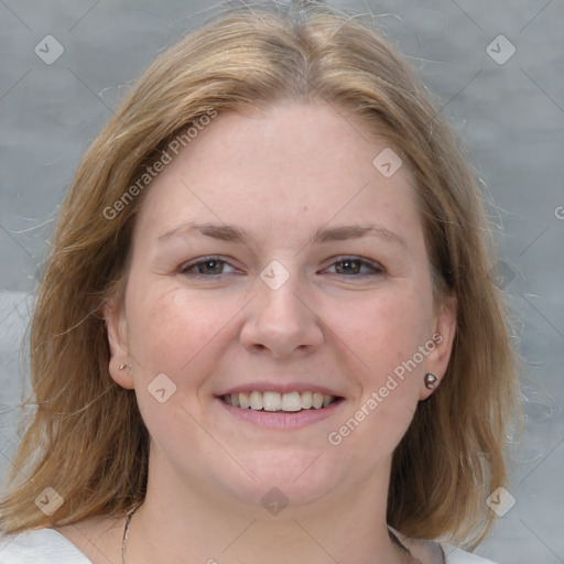 Joyful white young-adult female with medium  brown hair and blue eyes