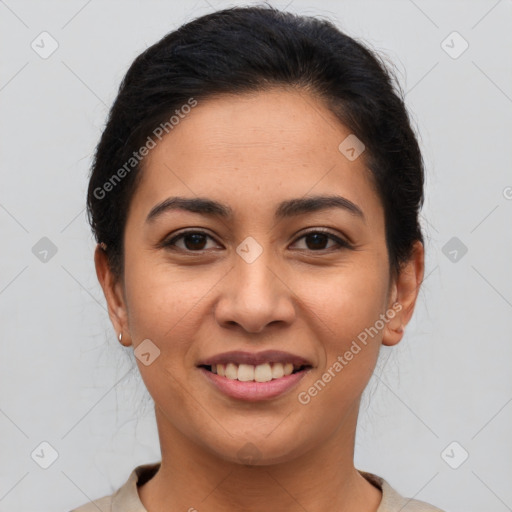 Joyful latino young-adult female with medium  brown hair and brown eyes