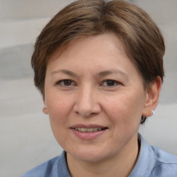 Joyful white adult female with medium  brown hair and brown eyes