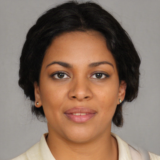 Joyful black young-adult female with medium  brown hair and brown eyes