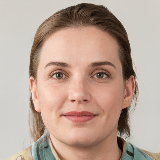 Joyful white young-adult female with medium  brown hair and grey eyes