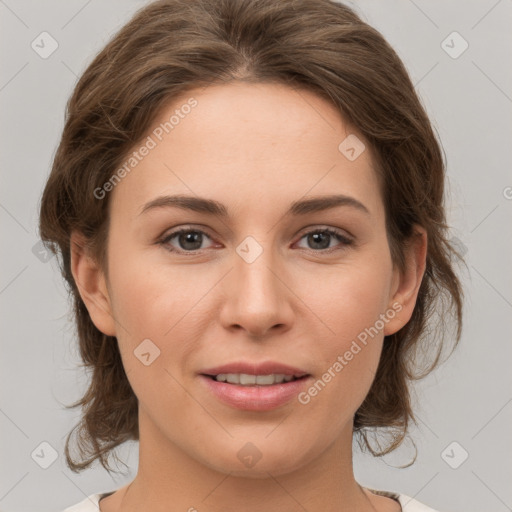 Joyful white young-adult female with medium  brown hair and grey eyes