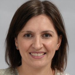 Joyful white adult female with medium  brown hair and brown eyes