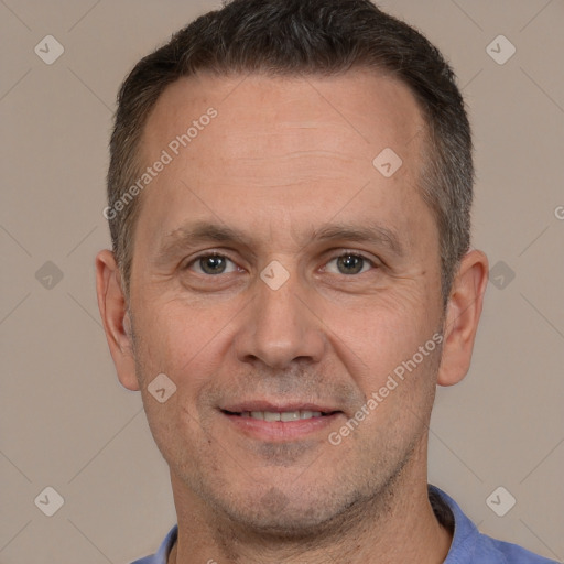 Joyful white adult male with short  brown hair and brown eyes