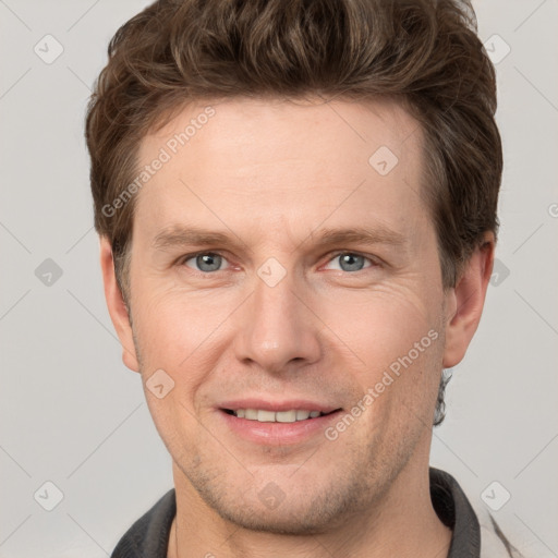 Joyful white adult male with short  brown hair and grey eyes