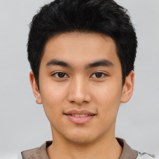 Joyful asian young-adult male with short  black hair and brown eyes