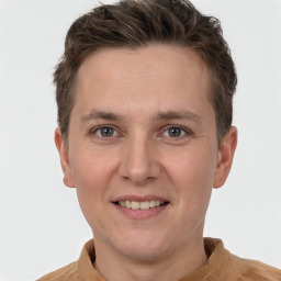 Joyful white adult male with short  brown hair and grey eyes