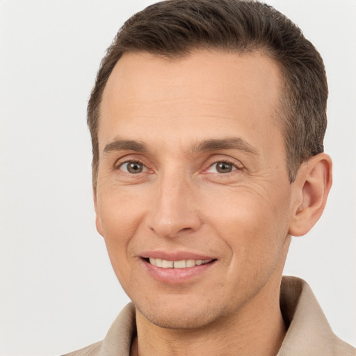 Joyful white adult male with short  brown hair and brown eyes