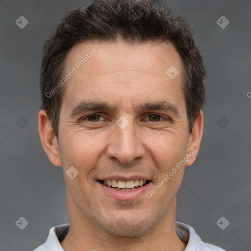 Joyful white adult male with short  brown hair and brown eyes