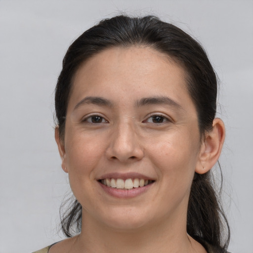 Joyful white young-adult female with medium  brown hair and brown eyes