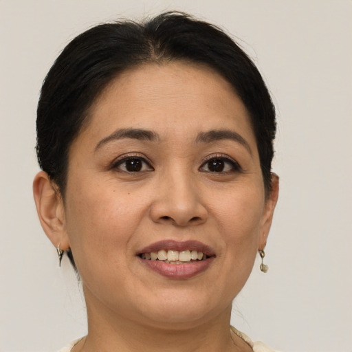 Joyful white adult female with short  brown hair and brown eyes