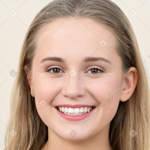 Joyful white young-adult female with long  brown hair and blue eyes