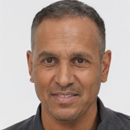 Joyful white adult male with short  black hair and brown eyes