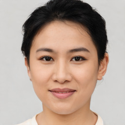 Joyful asian young-adult female with short  brown hair and brown eyes