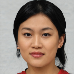 Joyful asian young-adult female with medium  black hair and brown eyes