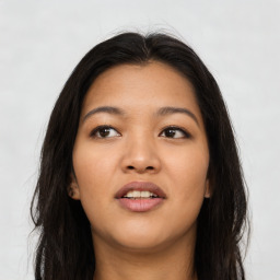 Joyful asian young-adult female with long  brown hair and brown eyes