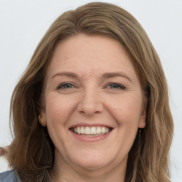 Joyful white adult female with medium  brown hair and grey eyes