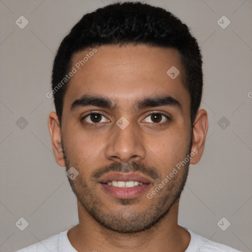 Joyful latino young-adult male with short  black hair and brown eyes