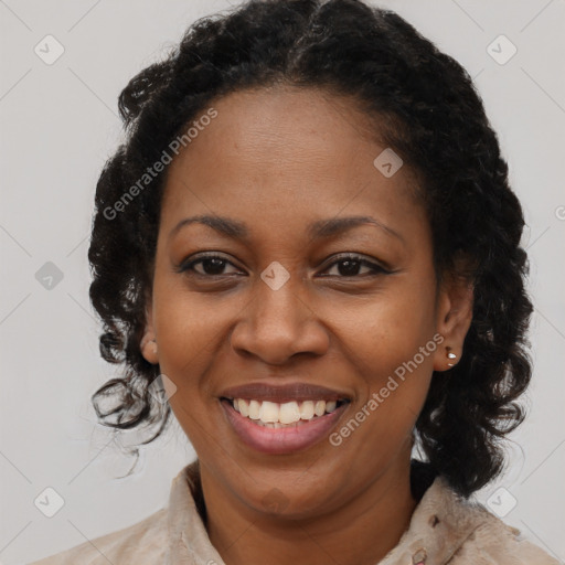 Joyful black adult female with long  brown hair and brown eyes