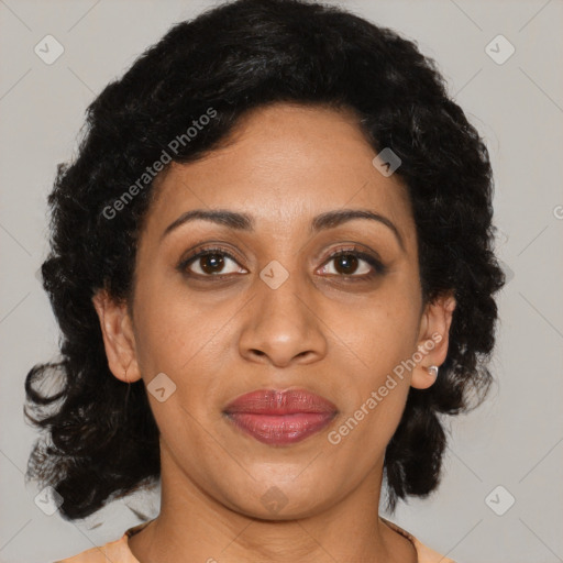 Joyful latino adult female with medium  brown hair and brown eyes