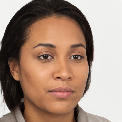 Joyful latino young-adult female with medium  brown hair and brown eyes