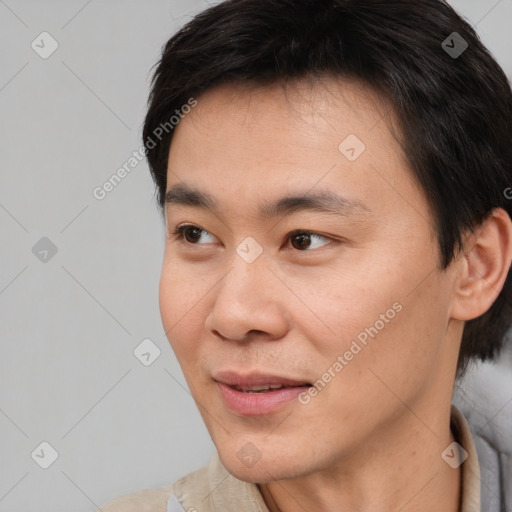 Joyful asian young-adult male with short  brown hair and brown eyes