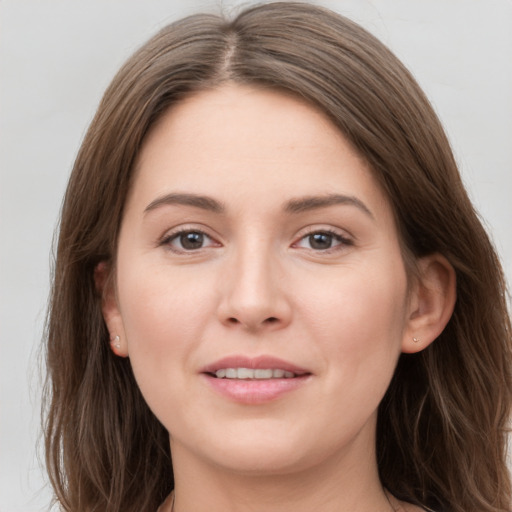 Joyful white young-adult female with long  brown hair and grey eyes