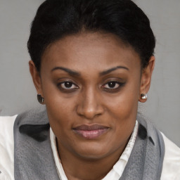 Joyful black young-adult female with short  brown hair and brown eyes