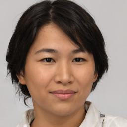 Joyful asian young-adult female with medium  brown hair and brown eyes